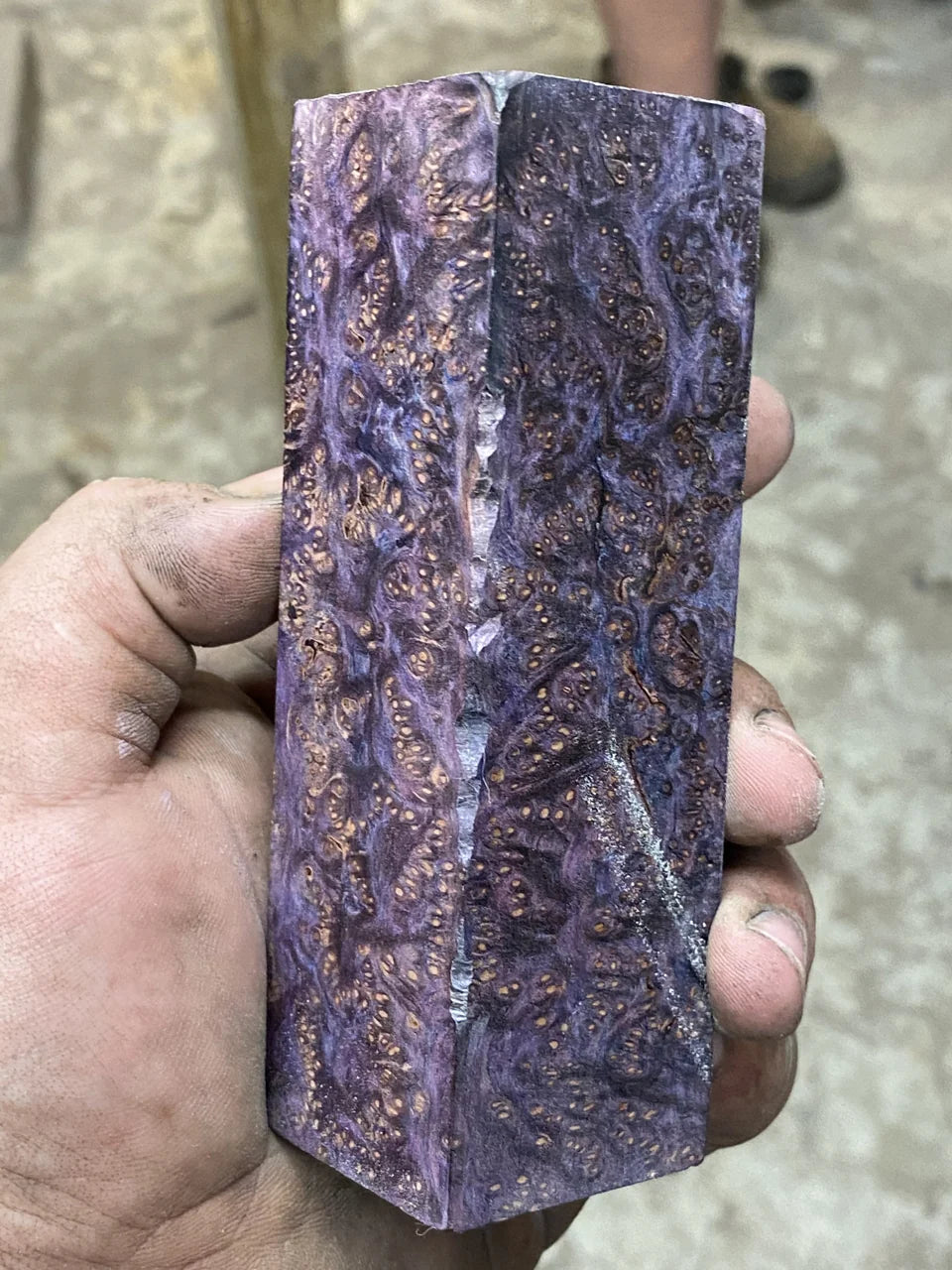 Purple figuring seen across a handle block.