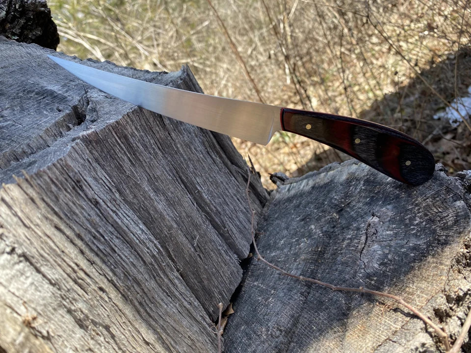 A finished blade with a red-and-black handle.