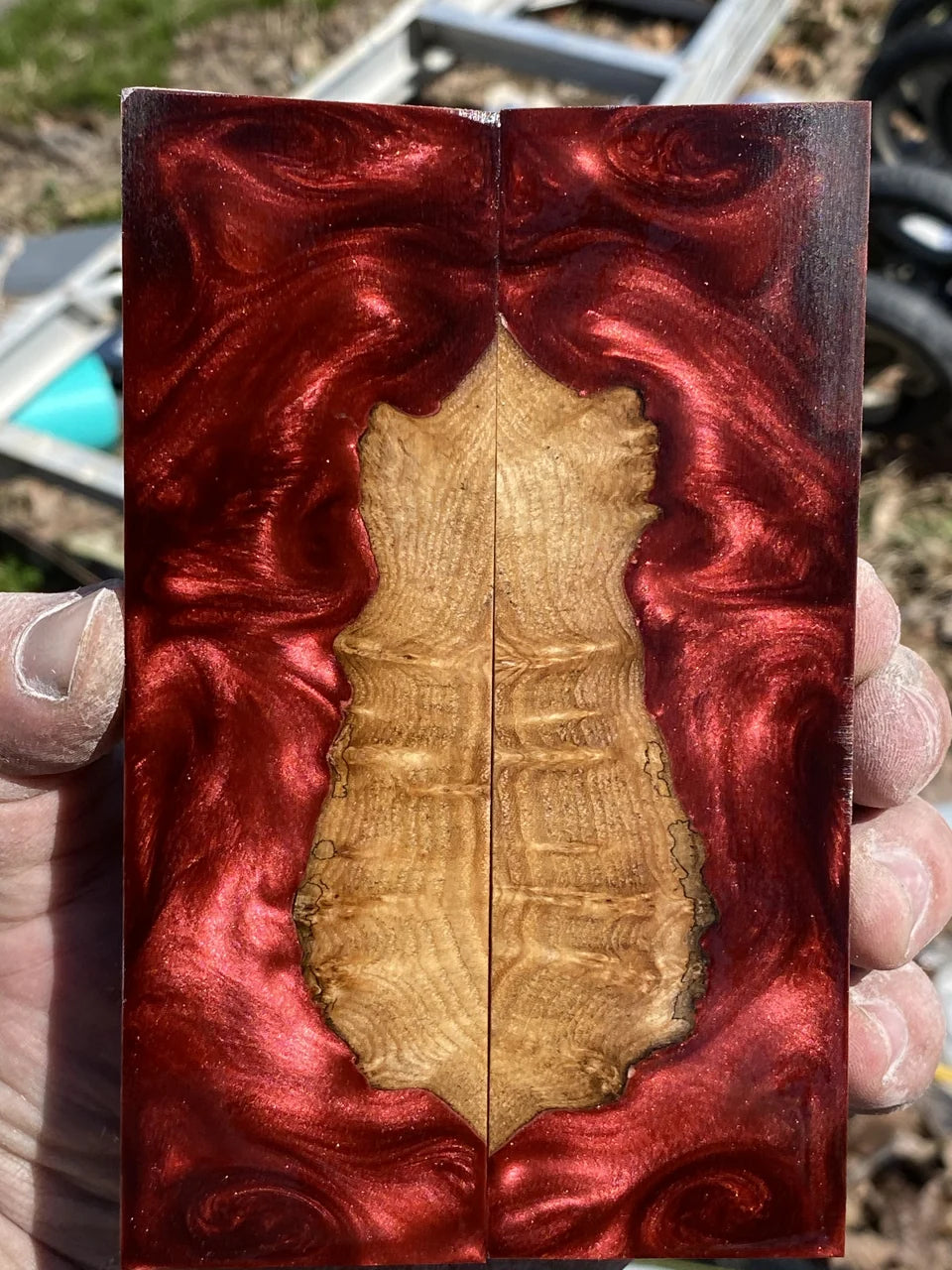 Natural wood framed by red resin.